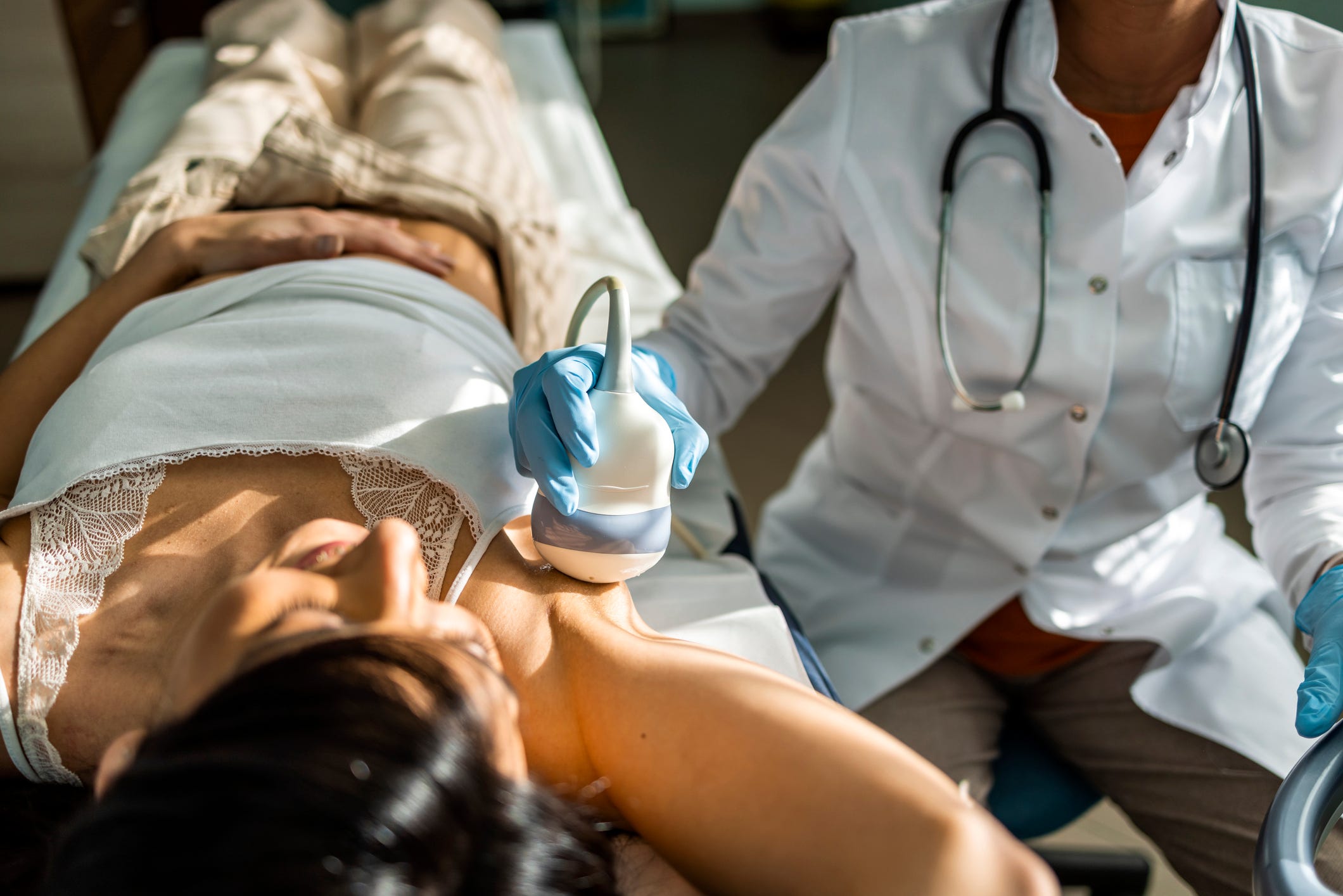 A woman gets a breast ultra-sound.