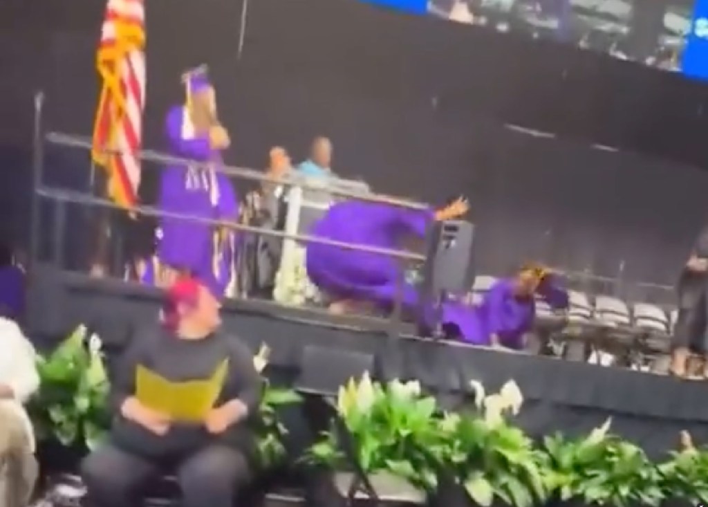 The force of the collision caused the two graduates to fall down to the shock of the other students and school officials.