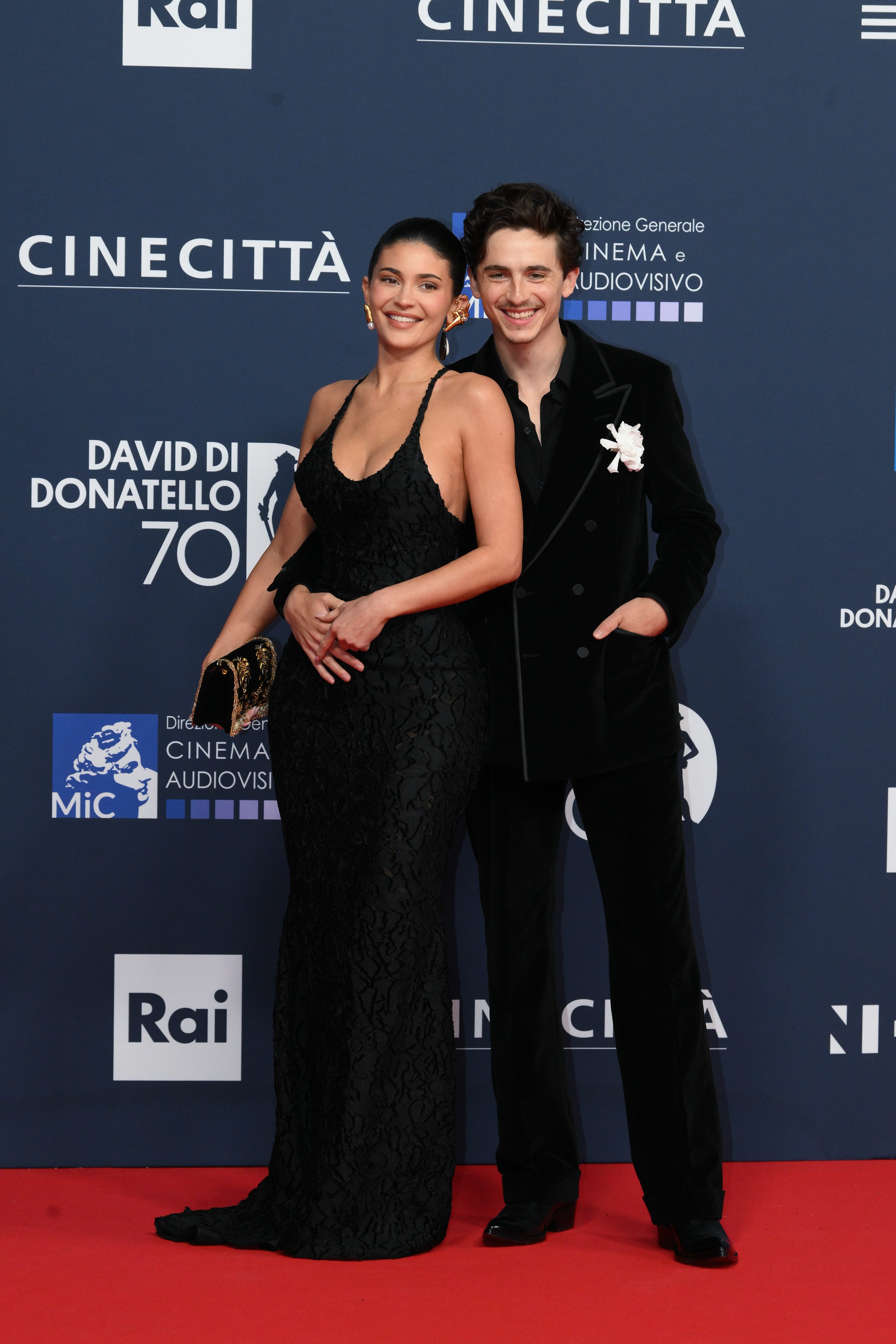 Kylie Jenner and Timothée Chalamet embrace on a red carpet.