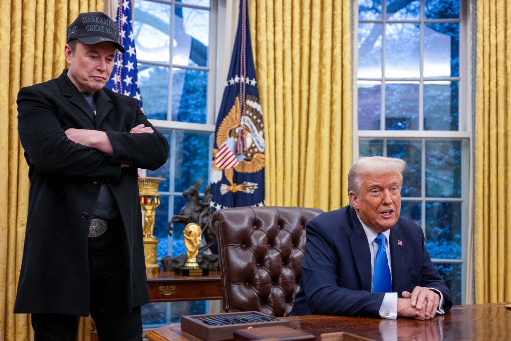Elon Musk standing next to Donald Trump in the Oval Office