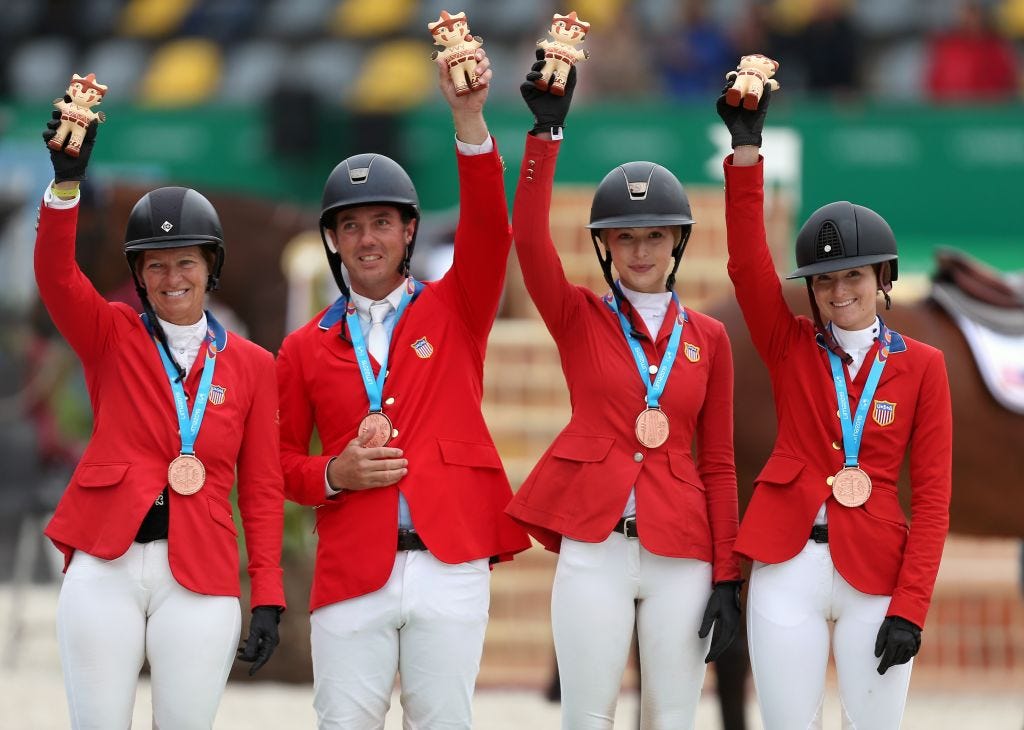 Eve Jobs (second from right) celebrates a bronze medal win with her teammates at the 2019 Pan-American Games.