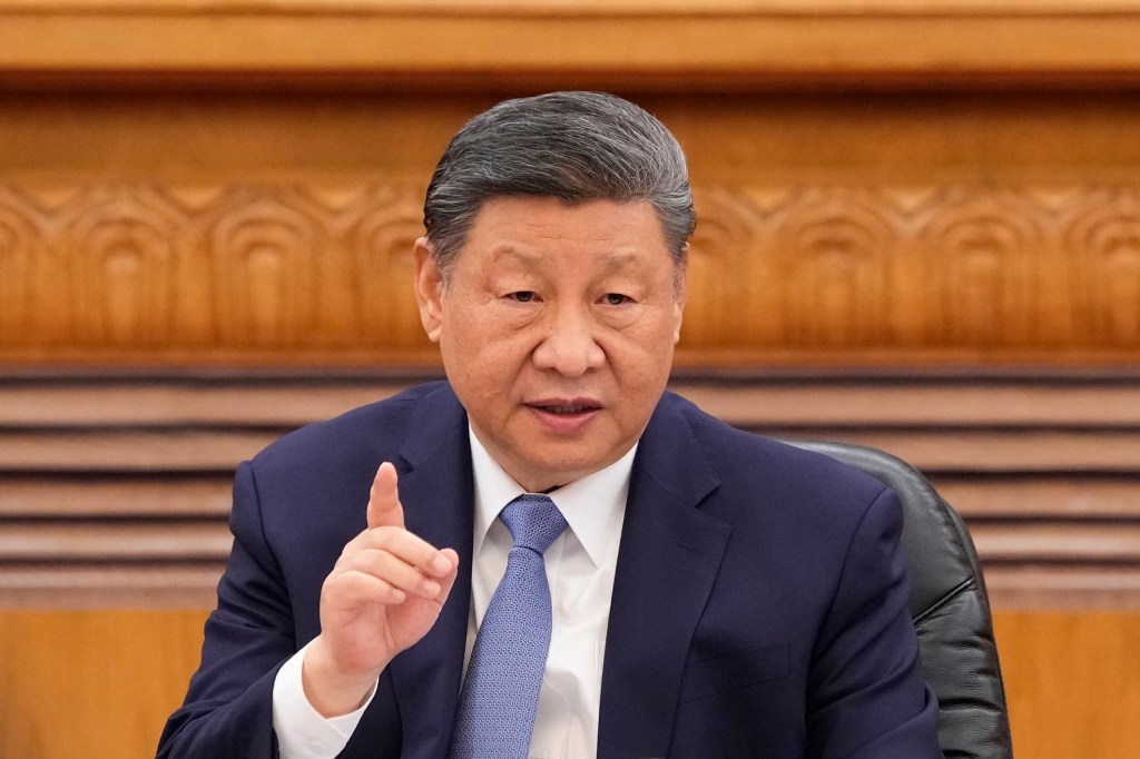 Xi Jinping speaking at a meeting with global business leaders.