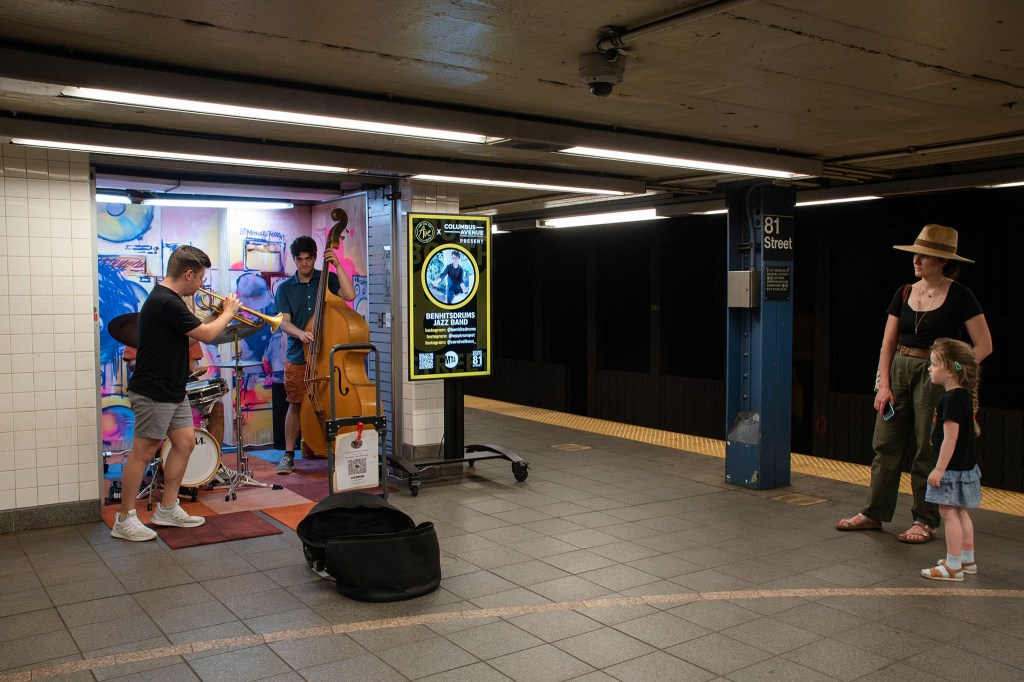 Subway musicians performing in a designated area.