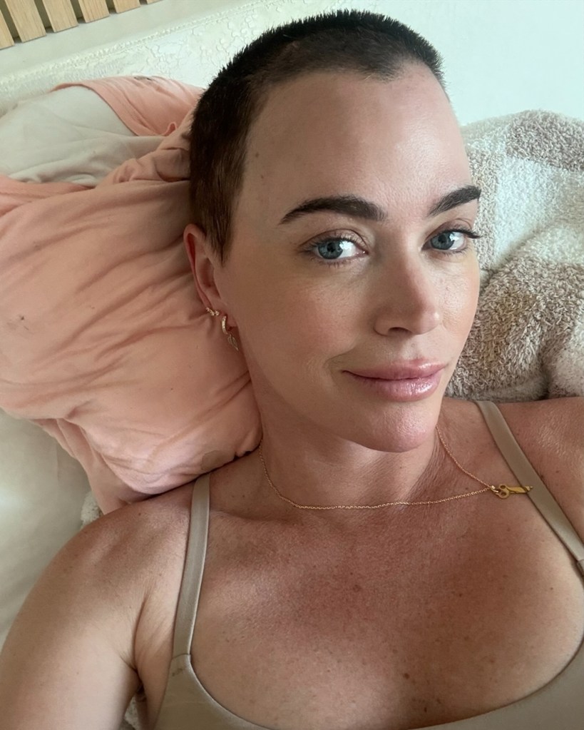 Teddi Mellencamp lying in bed.