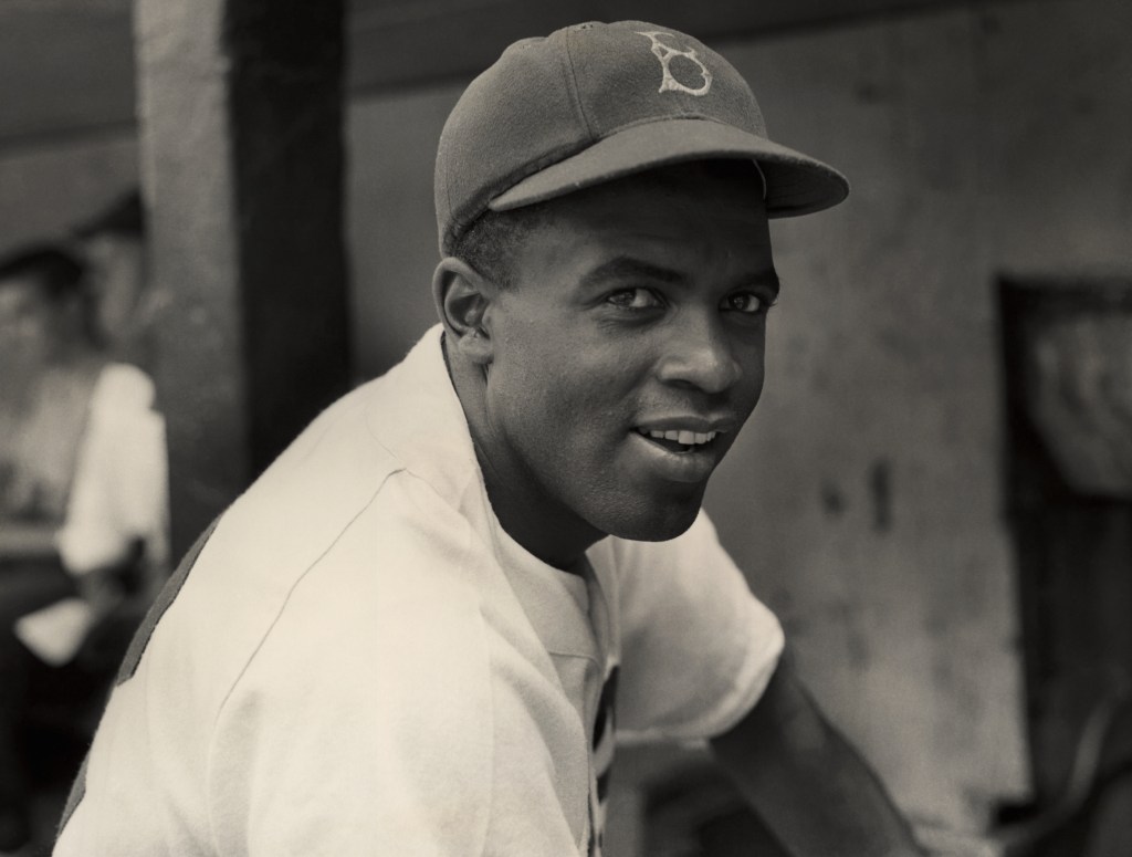 Black and white photo of Jackie Robinson in a Brooklyn Dodgers uniform.