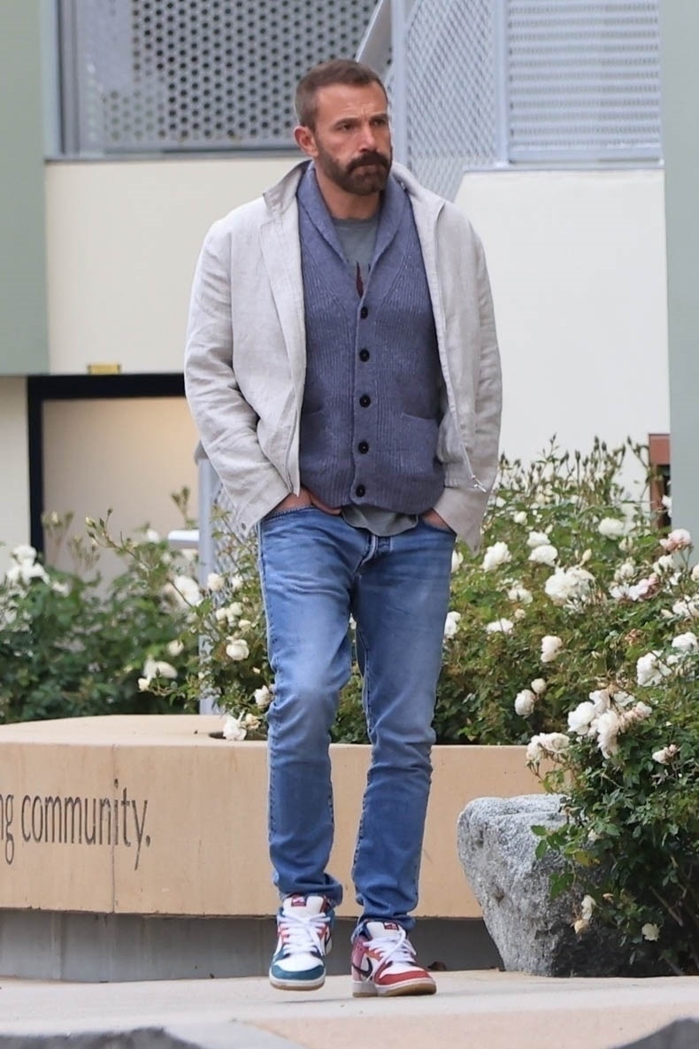 Ben Affleck walks outdoors. 