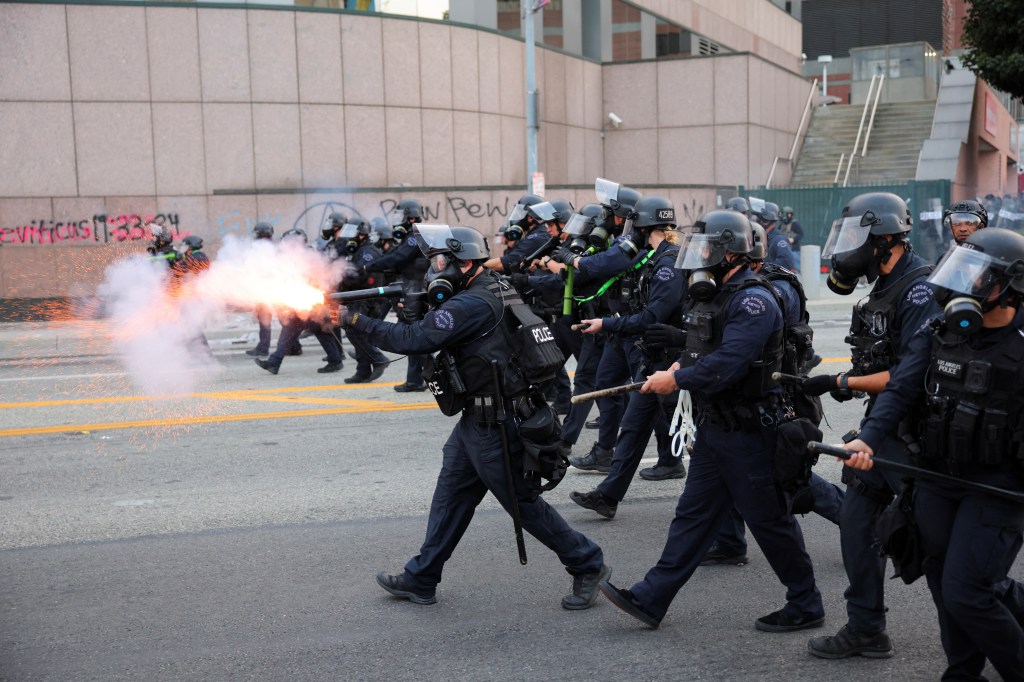 A police officer uses stun grenades as they approach the protesters gathered around the Los Angeles Federal Building following multiple detentions by Immigration and Customs Enforcement (ICE), in downtown Los Angeles, California, U.S., June 6, 2025.
