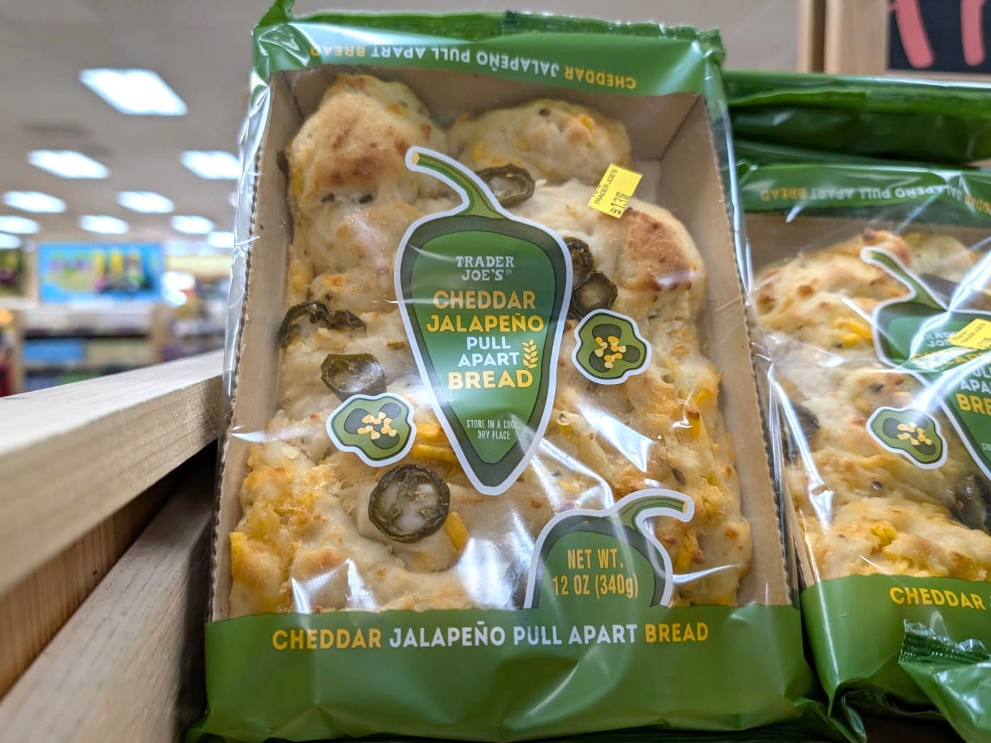 Packages of cheddar jalapeño pull-apart bread on the shelf at Trader Joe's.