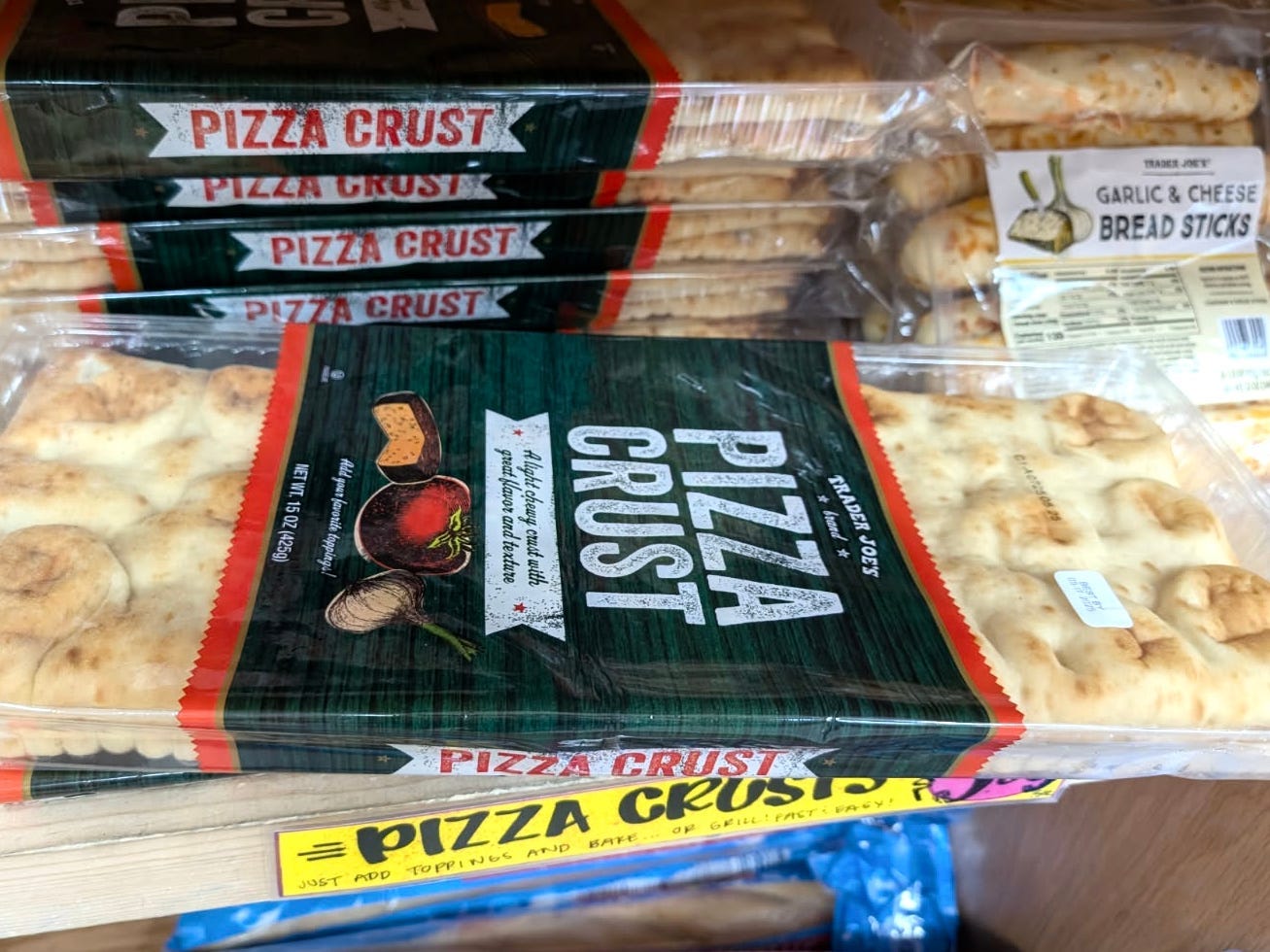 Packages of pizza crust on the shelf at Trader Joe's.