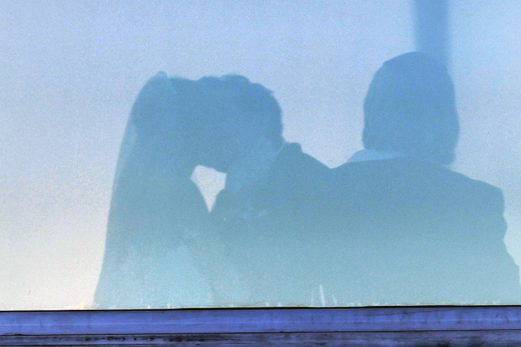 Brooklyn Beckham and Nicola Peltz Beckham share a kiss in the shadows.