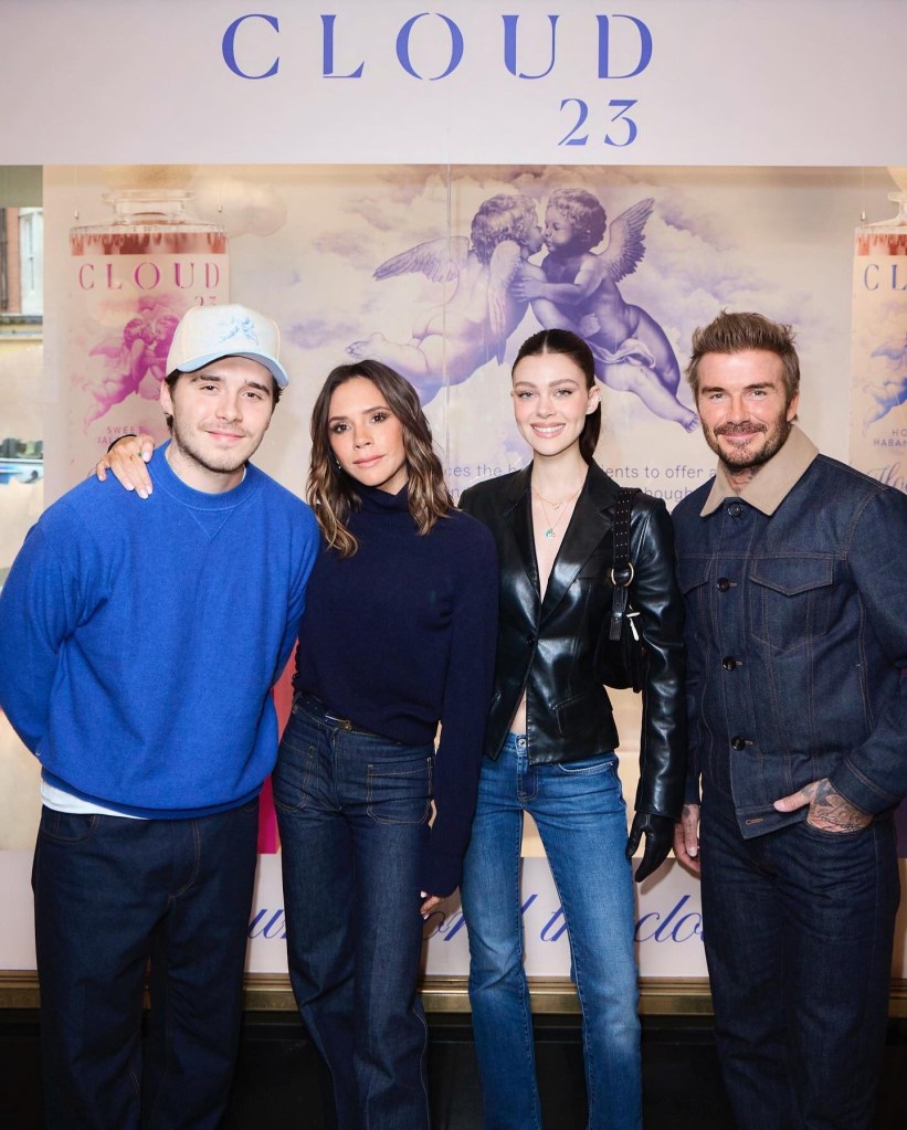 David Beckham in a denim jacket and dark pants, Nicola Peltz Beckham in a black leather jacket and jeans, Victoria Beckham in a black sweater and jeans, Brooklyn Beckham in a blue sweater, white baseball cap and black pants.