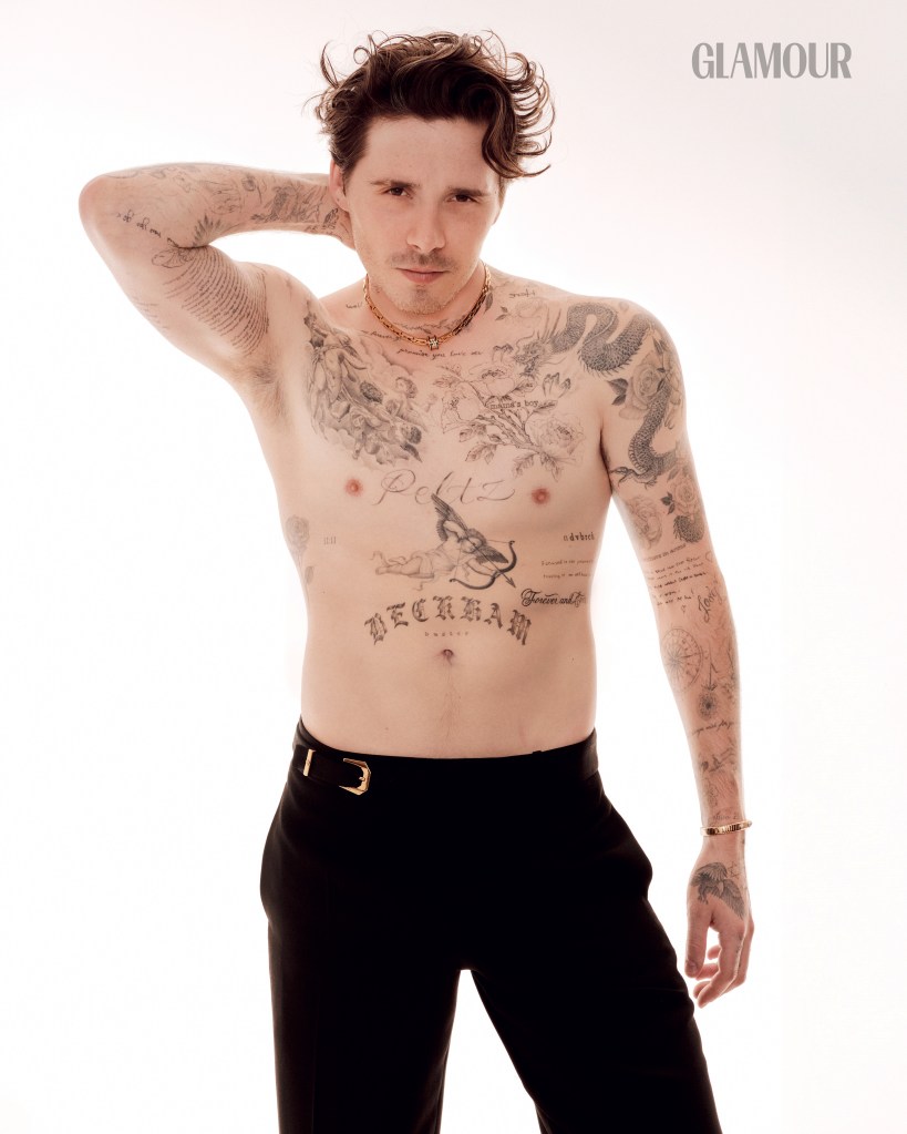 Brooklyn Beckham in black pants.