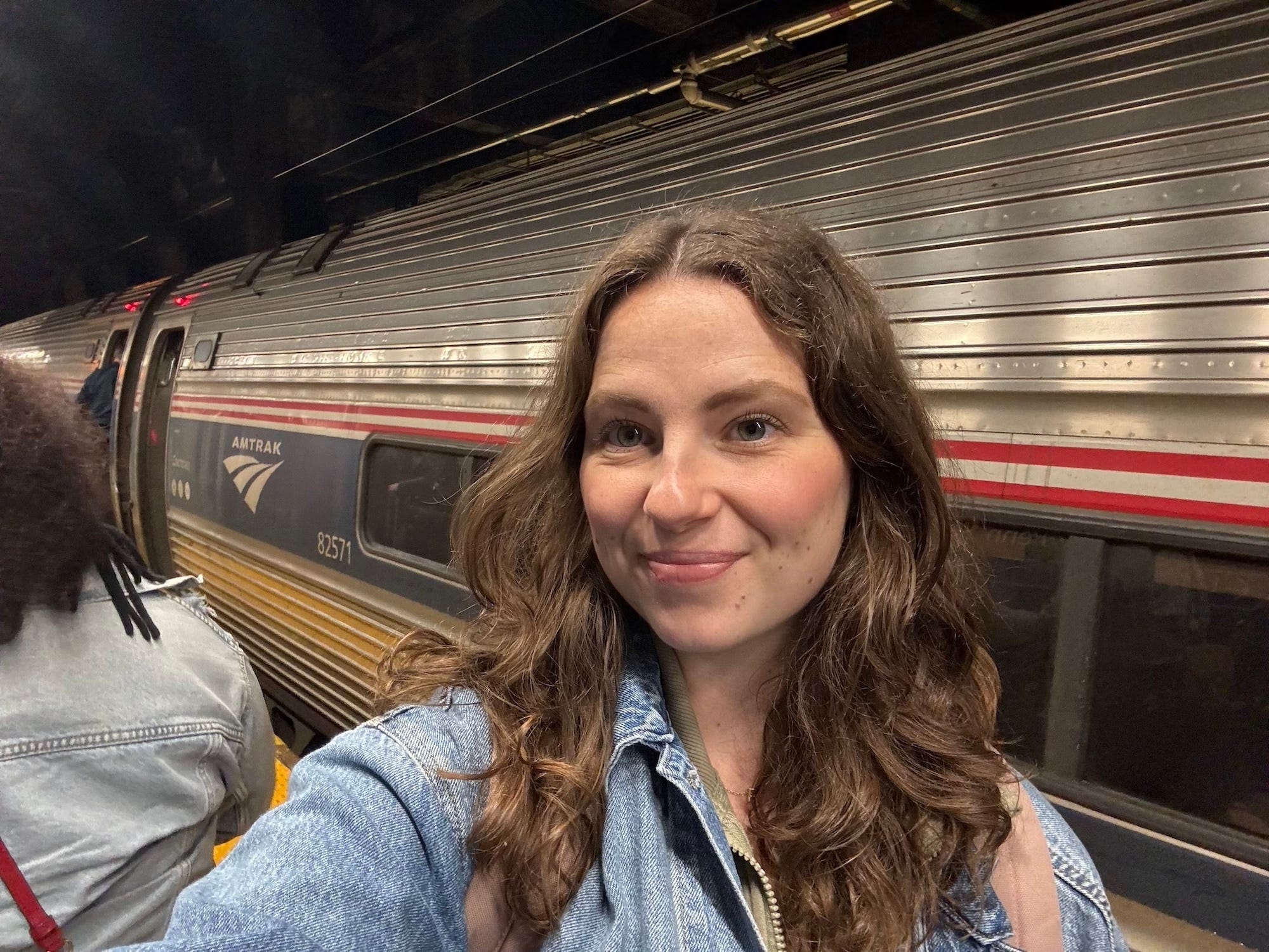 A selfie of a woman boarding an Amtrak train.