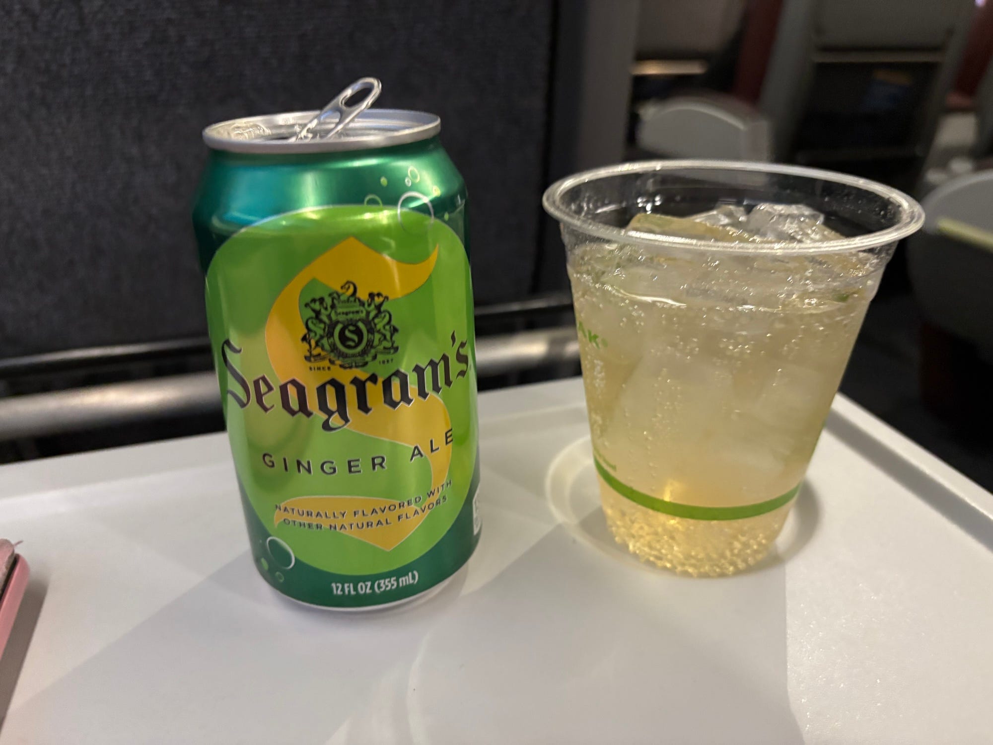 A ginger ale can and a cup full of it.