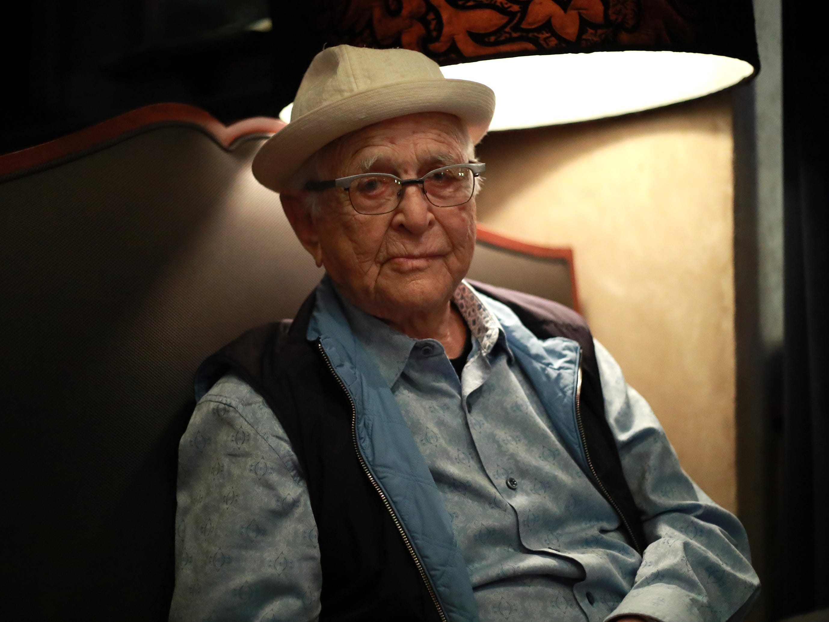 Norman Lear sitting in a char
