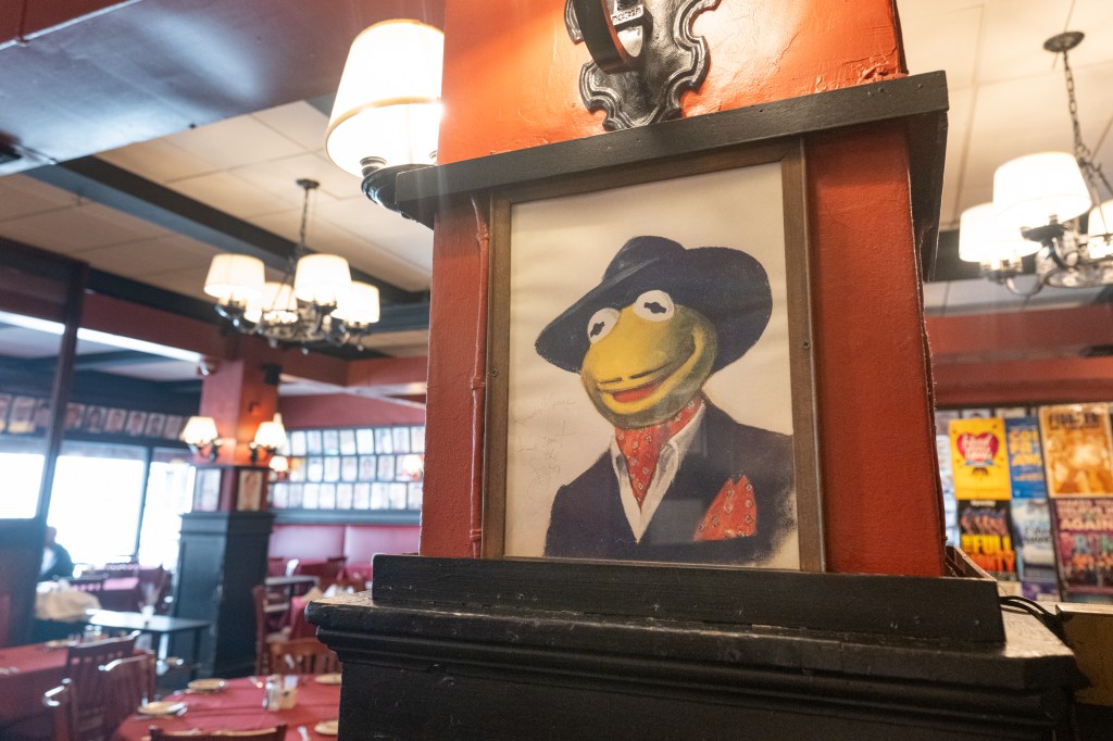 Framed illustration of Kermit the Frog in a suit and hat at Sardi's restaurant in Manhattan
