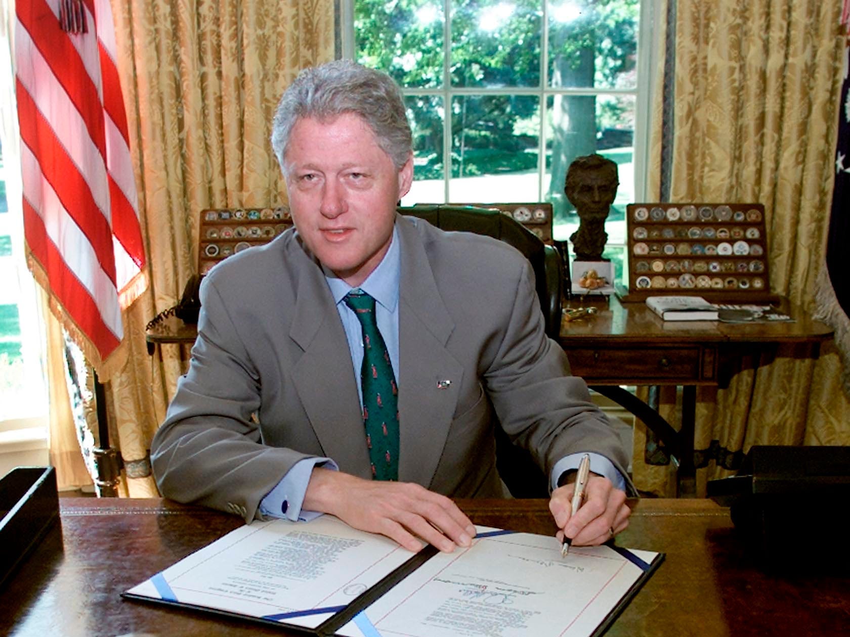 PRESIDENT CLINTON SIGNS IRS BILL IN OVAL OFFICE.