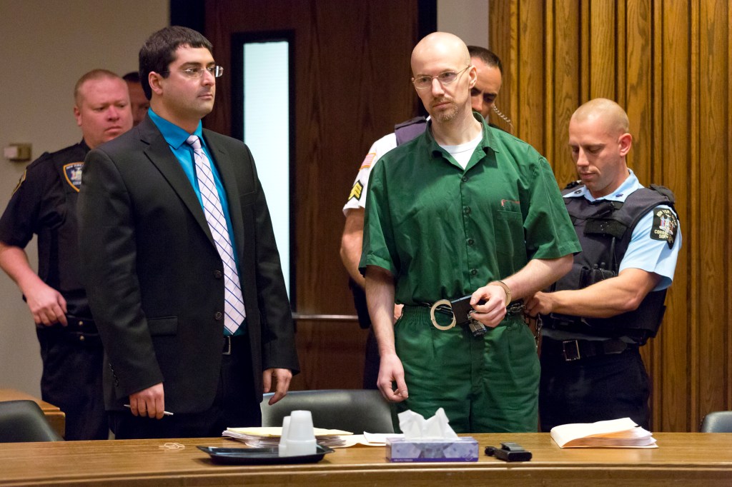 David Sweat in a green jumpsuit in court with his attorney on Nov. 13, 2015 he is surrounded by lawyers and court officers 