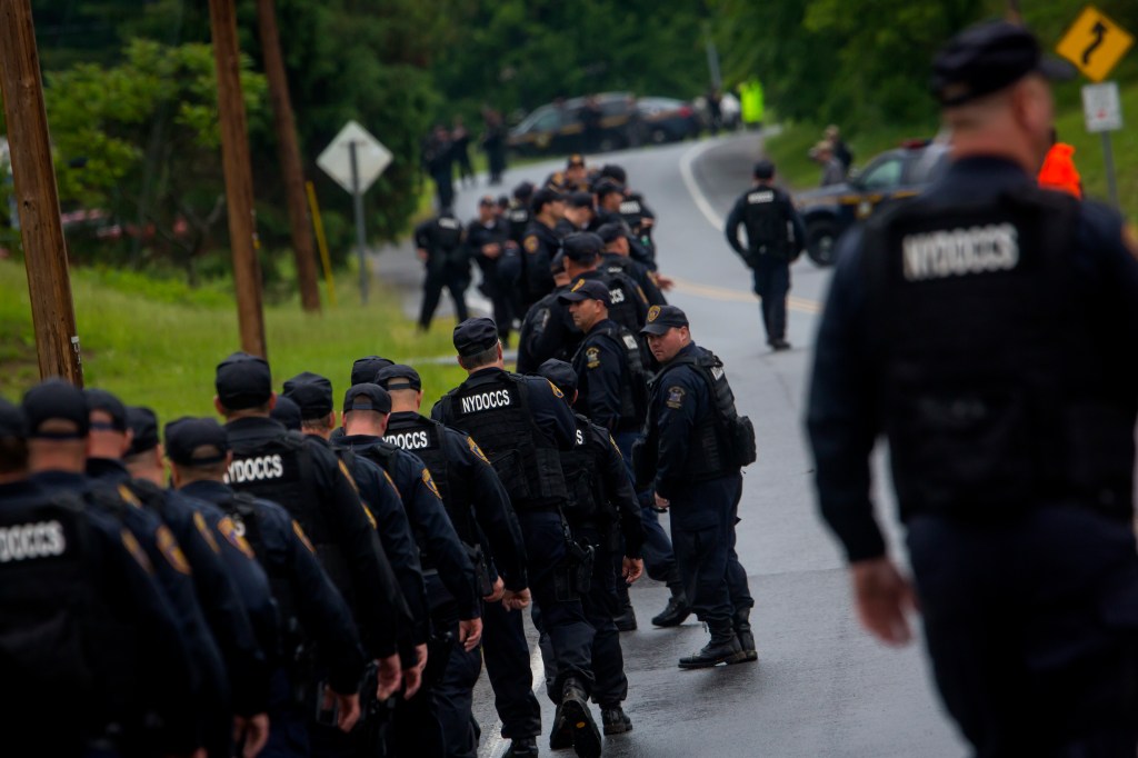 Police officers searching for Richard Matt and David Sweat on a road near Cadyville, New York, after the duo escaped from Clinton Correctional Facility on June 6, 2015