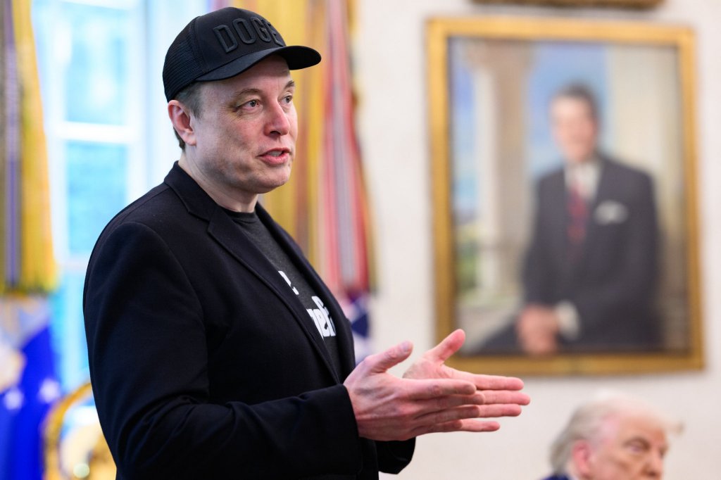 Elon Musk speaking at a press conference.