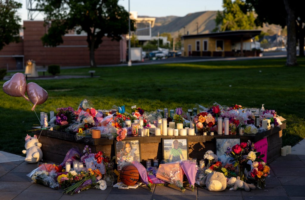 Pictures, flowers and candles mark a makeshift memorial Tuesday, June 3, 2025, in Wenatchee, Wash.