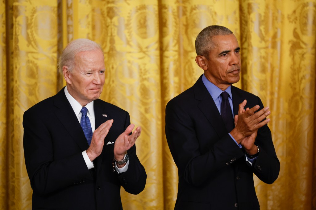 President Biden and President Obama clapping at the White House.