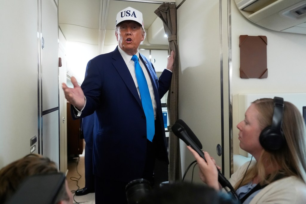 Donald Trump speaking to reporters aboard Air Force One.