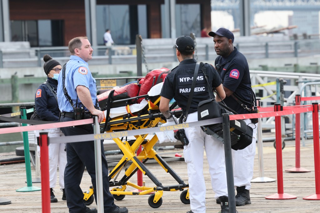 FDNY Lt supervisor and EMTs awaiting instructions at Pier 16 after a body found floating in the East River at 6am, friday, in Manhattan
