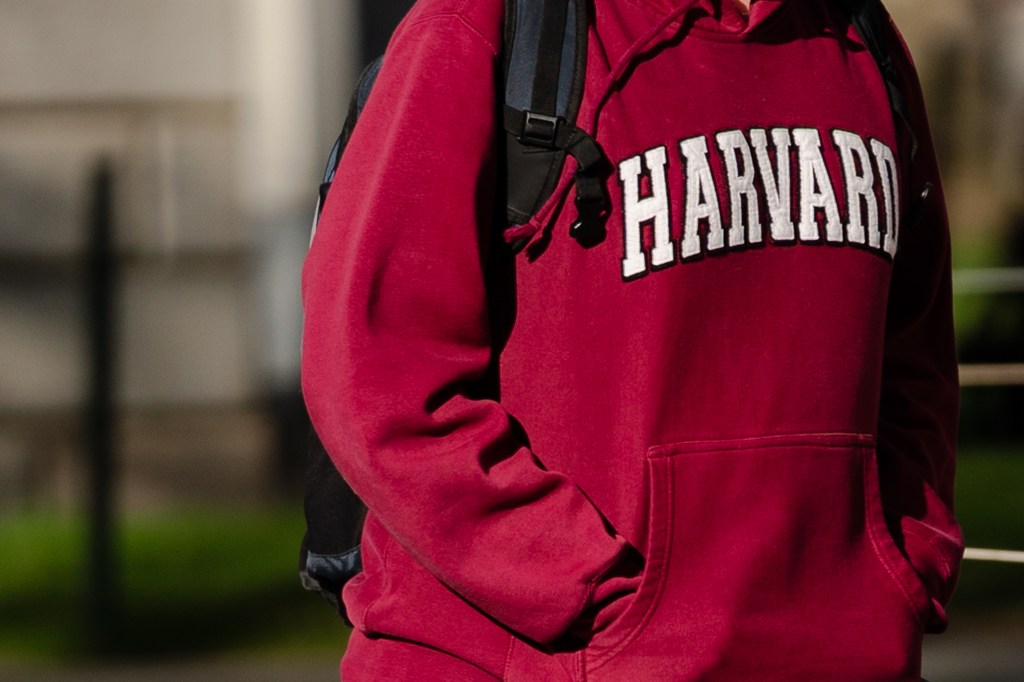 A pedestrian wearing a Harvard University sweatshirt on the Harvard University campus in Cambridge.
