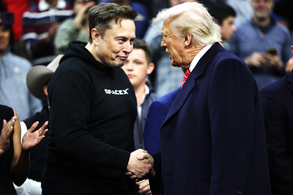 Elon Musk and Donald Trump shaking hands.