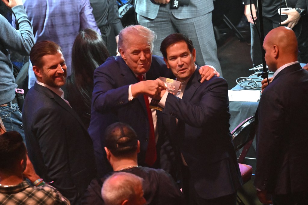 Donald Trump, Eric Trump, and Marco Rubio at a UFC event.
