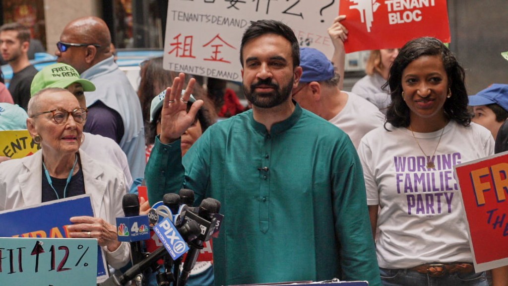 Zohran Mamdani at a press conference, being assaulted by a protestor.