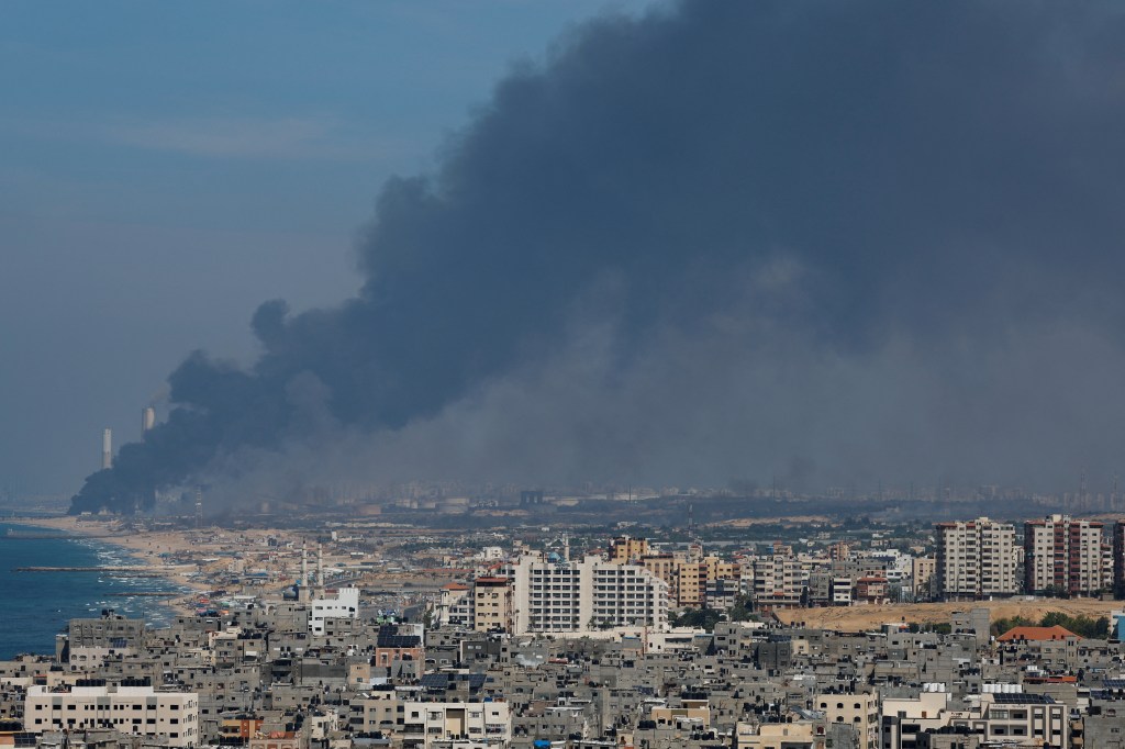 Smoke billows over coastal city following Hamas attack.