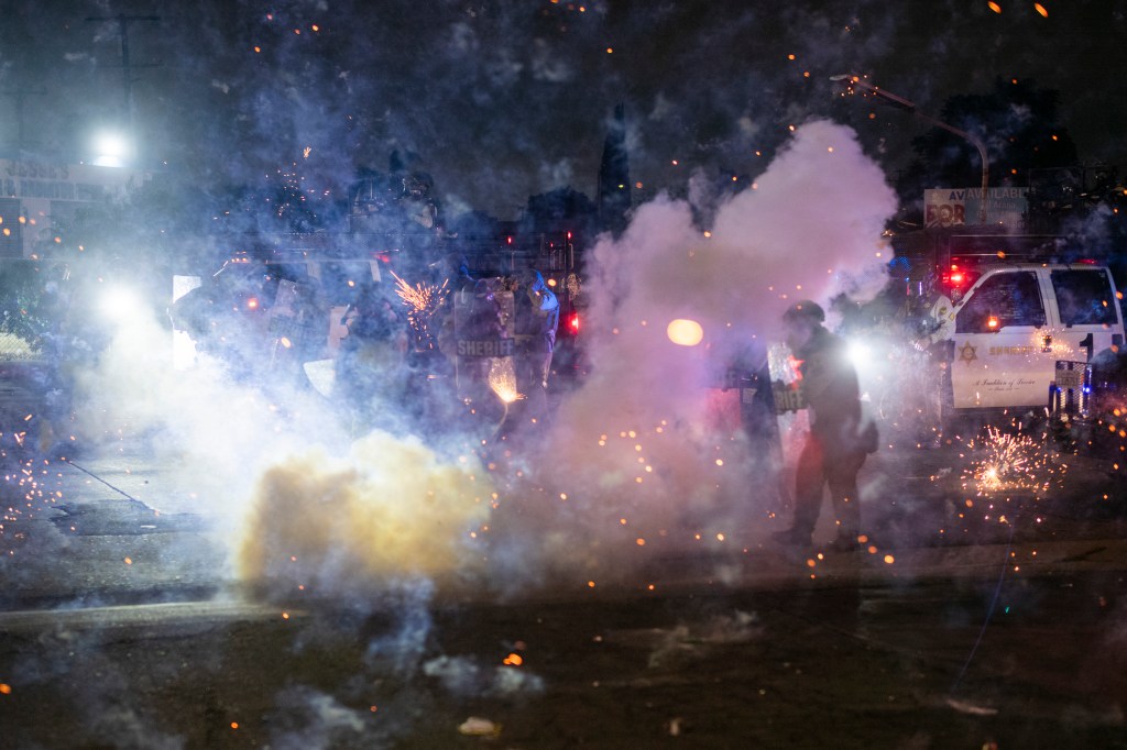 Fireworks are thrown at sheriff's deputies in the streets of Compton.