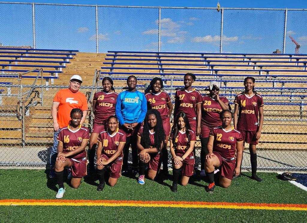 The Medgar Evers College Preparatory School's girls' varsity team, the Cougars, seen here in a group foto on a field, were kicked out after Eagle Academy gained control of the renovated field.