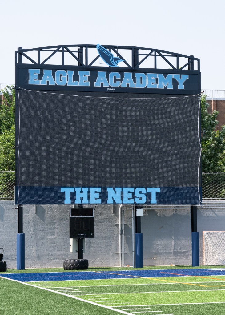 The Eagle Academy, which uses the field for football practice and games, has barred girls' soccer teams and other community groups that formerly played on it. scoreboard with eagle academy name and the nest on it