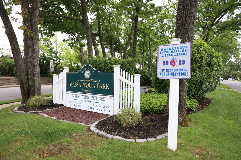 Massapequa Park welcome sign and 2023 12U Girls Softball World Champions sign.