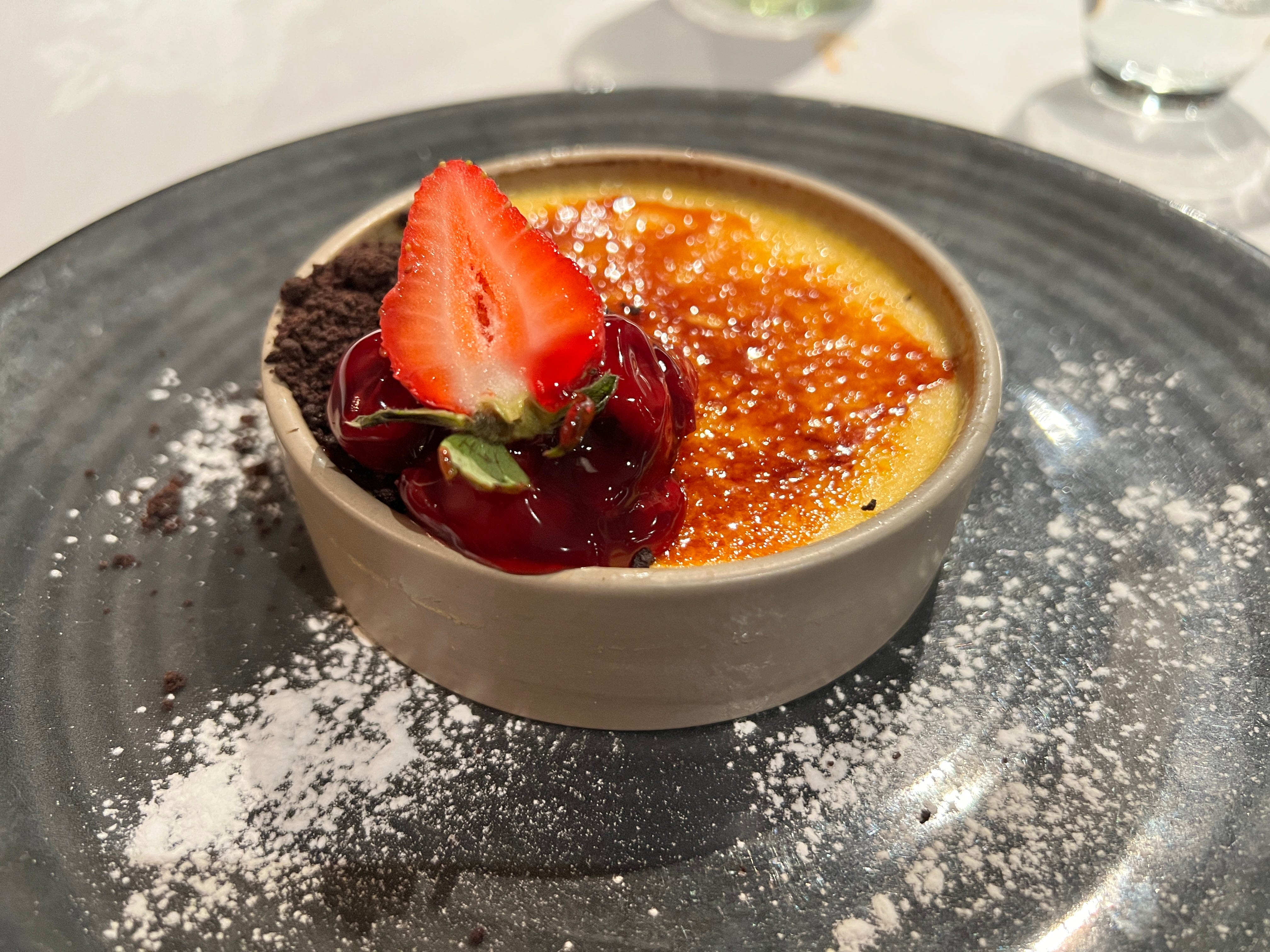 Creme brulee topped with strawberry half
