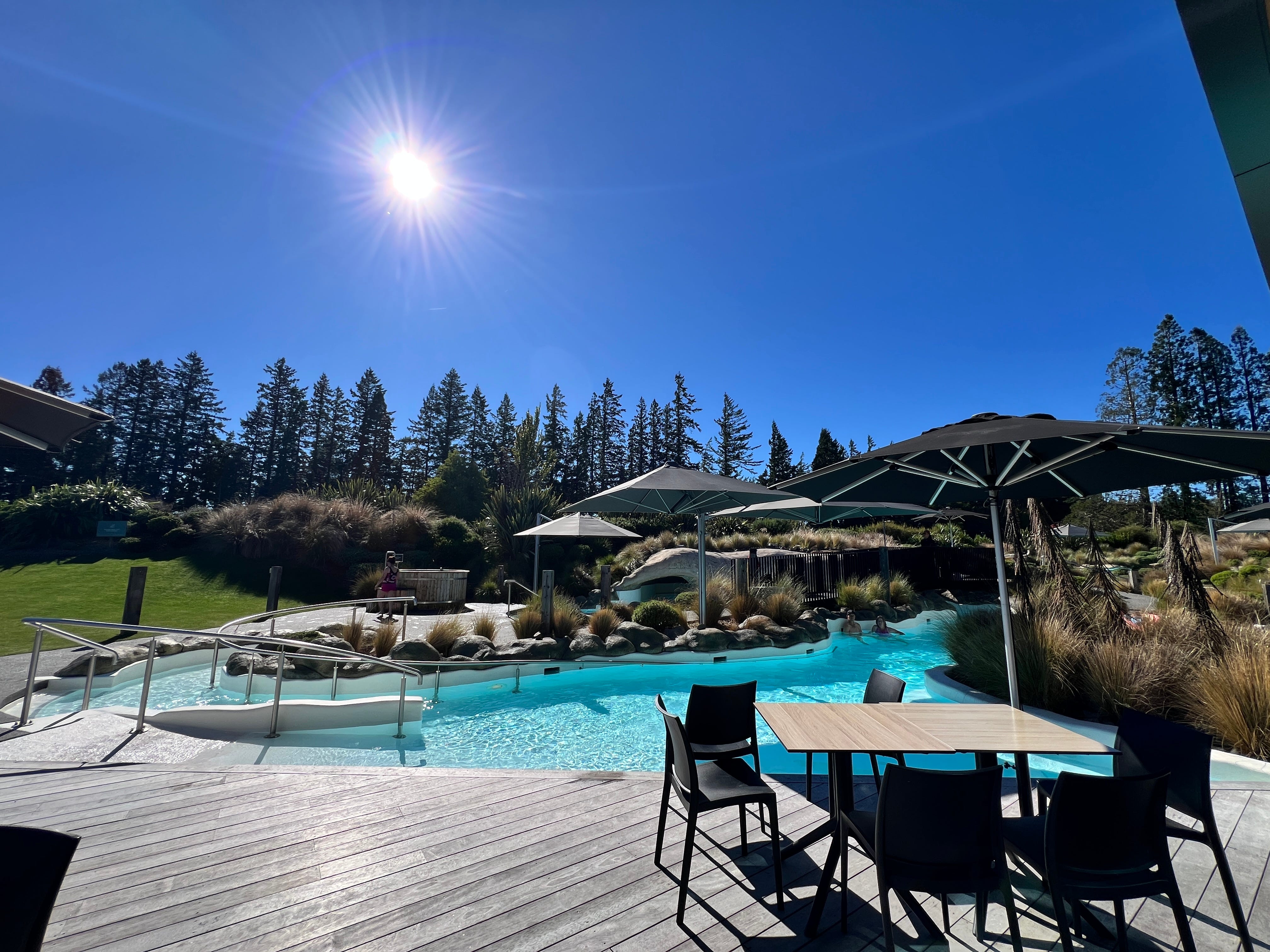 Opuke Thermal Pools and Spa outdoor area with pool, umbrellas