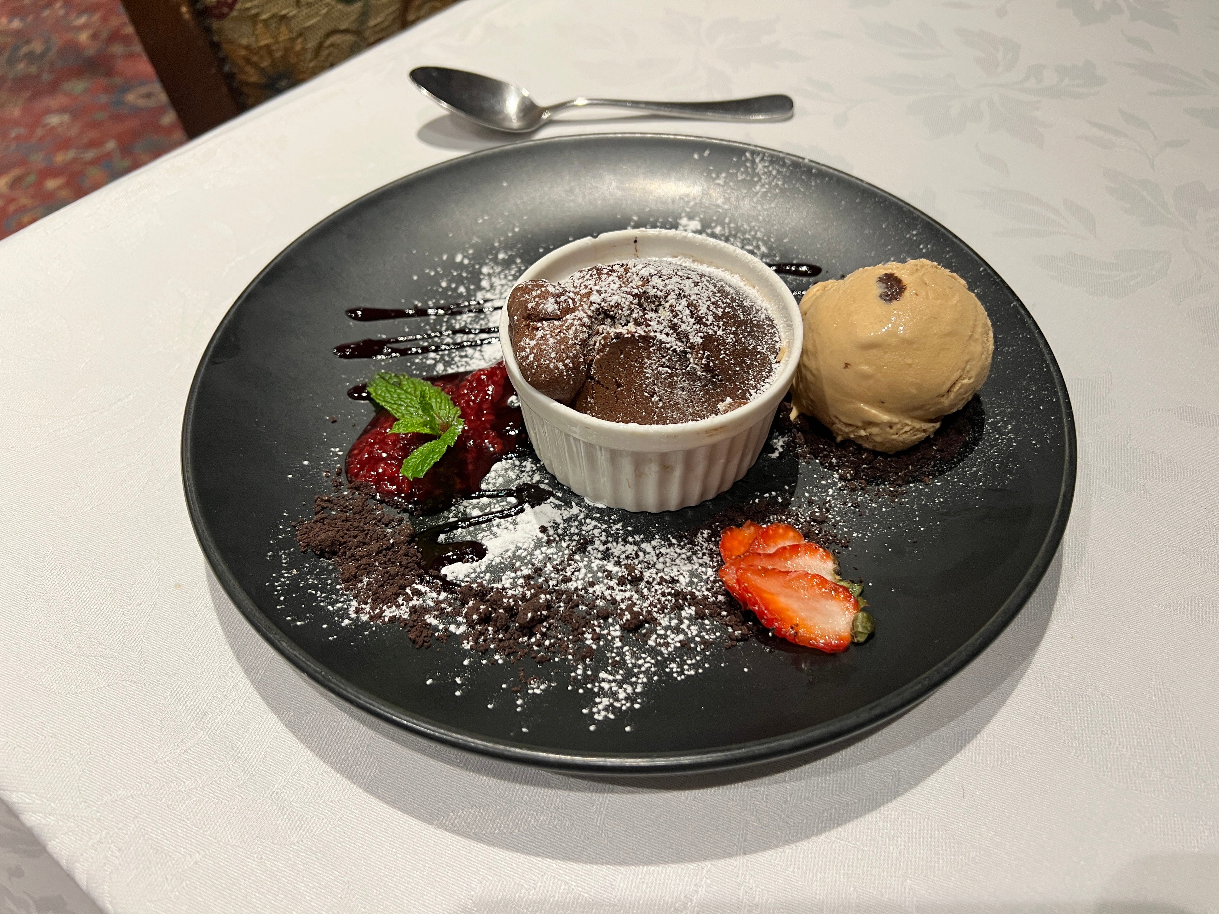 Chocolate cake in ramekin with scoop of ice cream