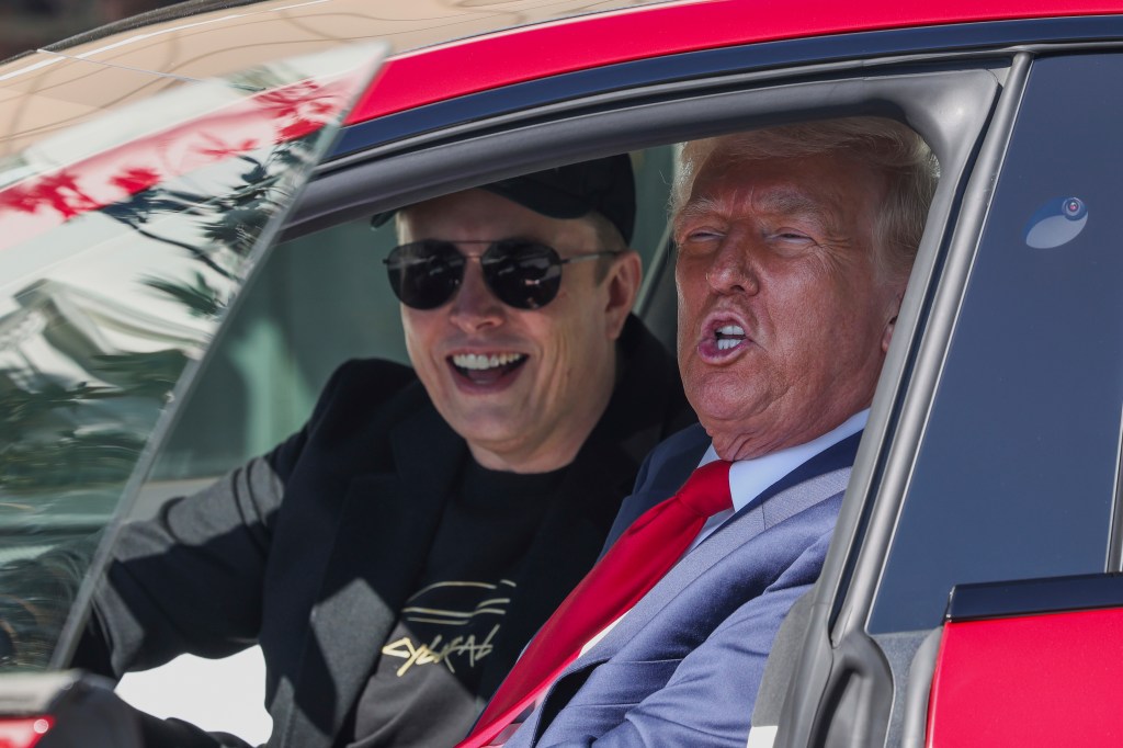Donald Trump and Elon Musk in a red Tesla.