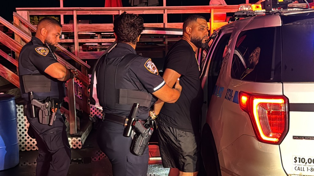 NYPD officers arresting Joshua Brito following a boat explosion.