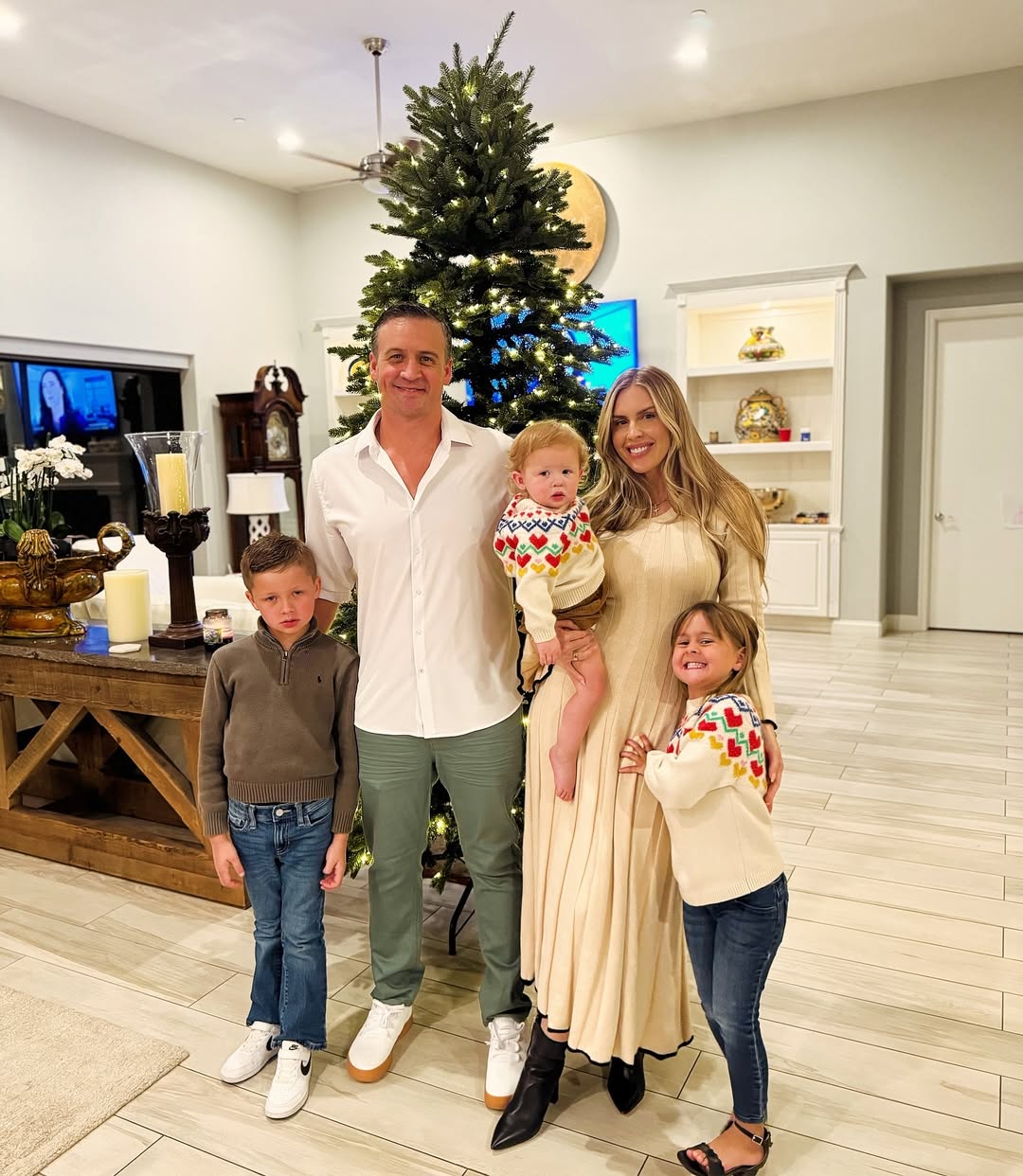 Ryan Lochte and Kayla Reid and their kids pose together.
