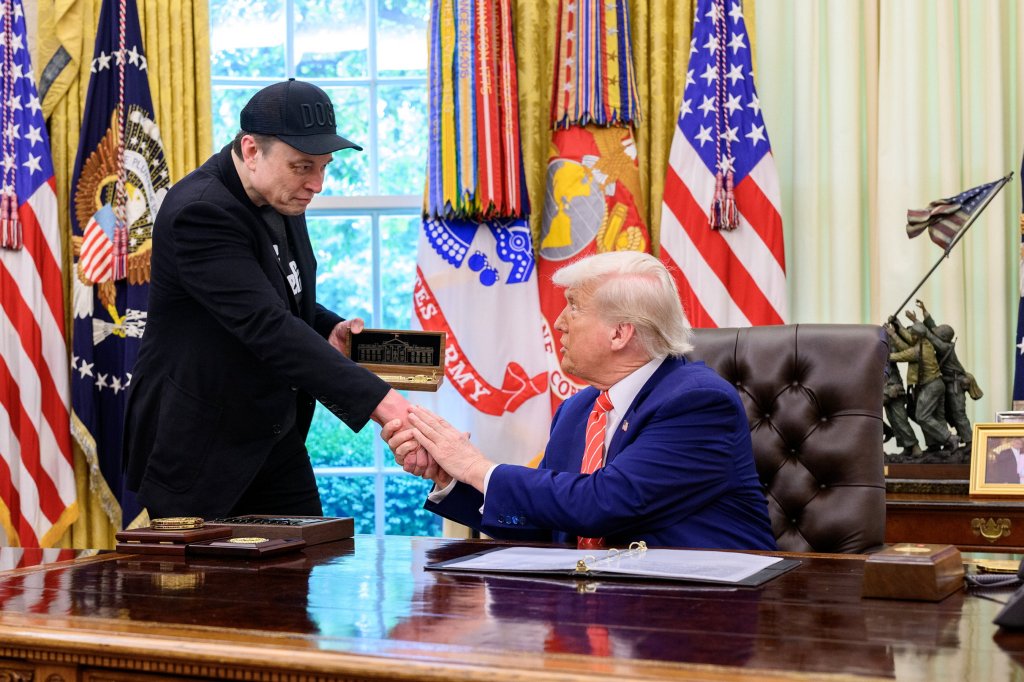 Elon Musk and Donald Trump shaking hands in the Oval Office.