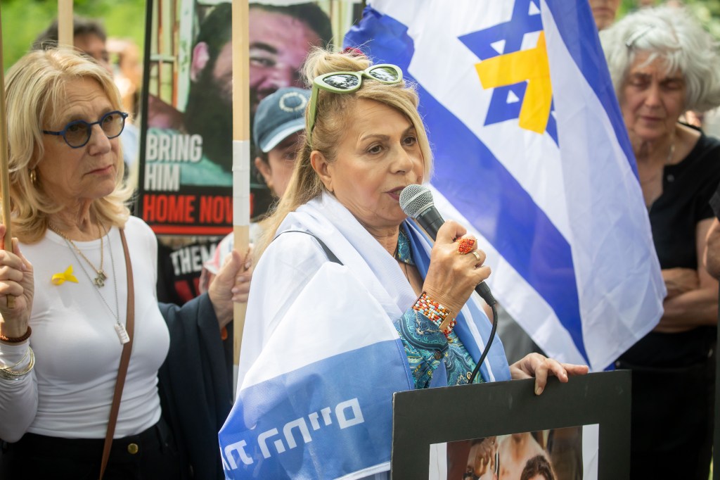 Woman speaking at a Bring Them Home NOW rally in NYC.