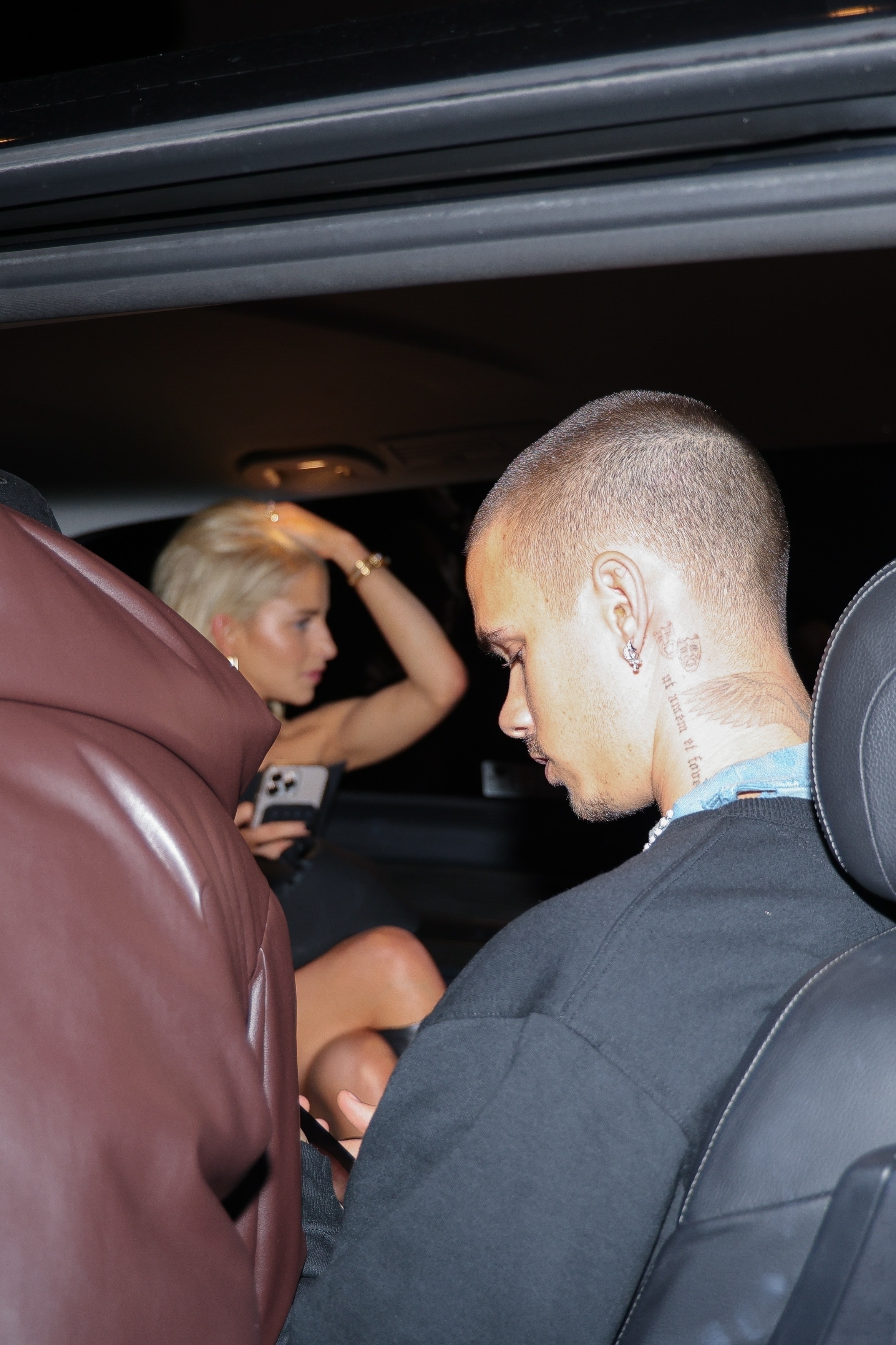 Romeo Beckham and Caro Daur in a car together outside a club in Paris.