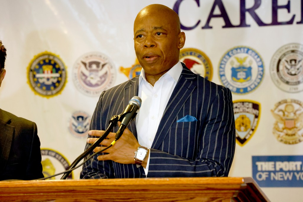 New York City Mayor Eric Adams speaking at a podium.