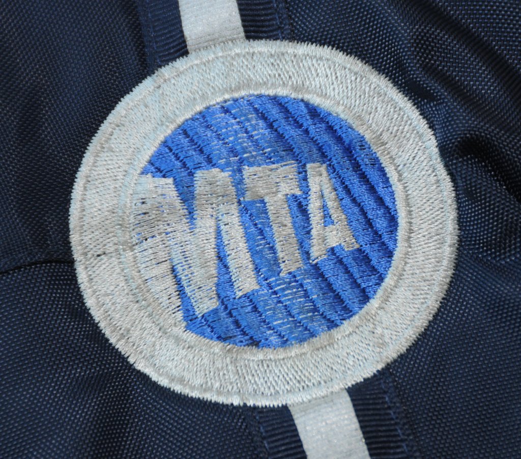 Close-up of an MTA logo embroidered on fabric.