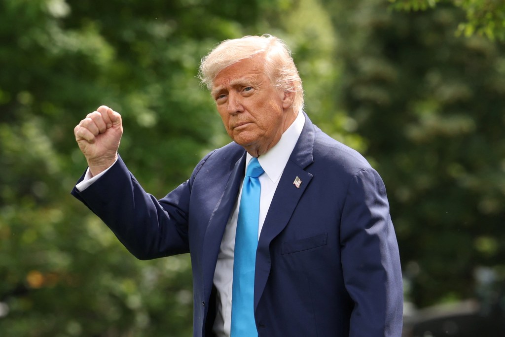 President Donald Trump leaving the White House with his fist raised.
