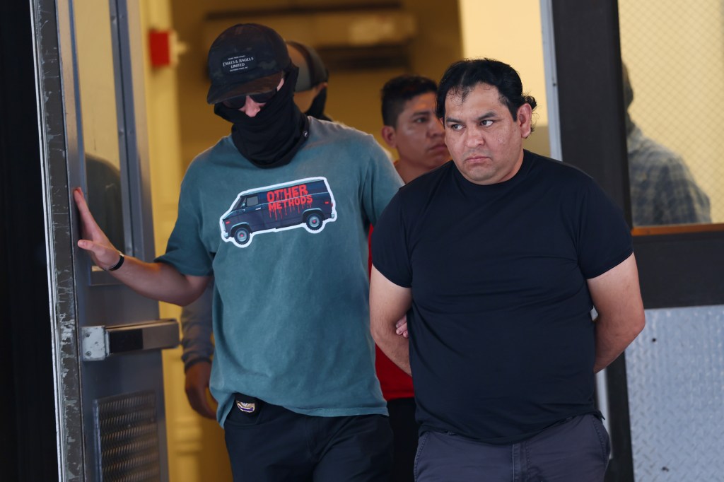 ICE agents escorting detainees at an NYC immigration court.